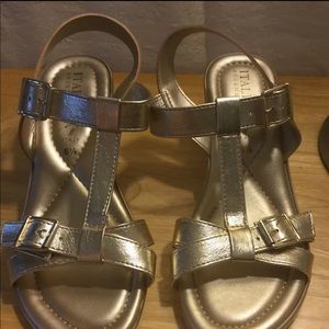 Italian shoemaker faux leather gold sandal heels.